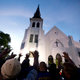 The men of Omega Psi Phi Fraternity Inc. lead a crowd of people in prayer outside the Emanuel AME Church, after a memorial service for the nine people killed by Dylann Roof in Charleston, S.C.